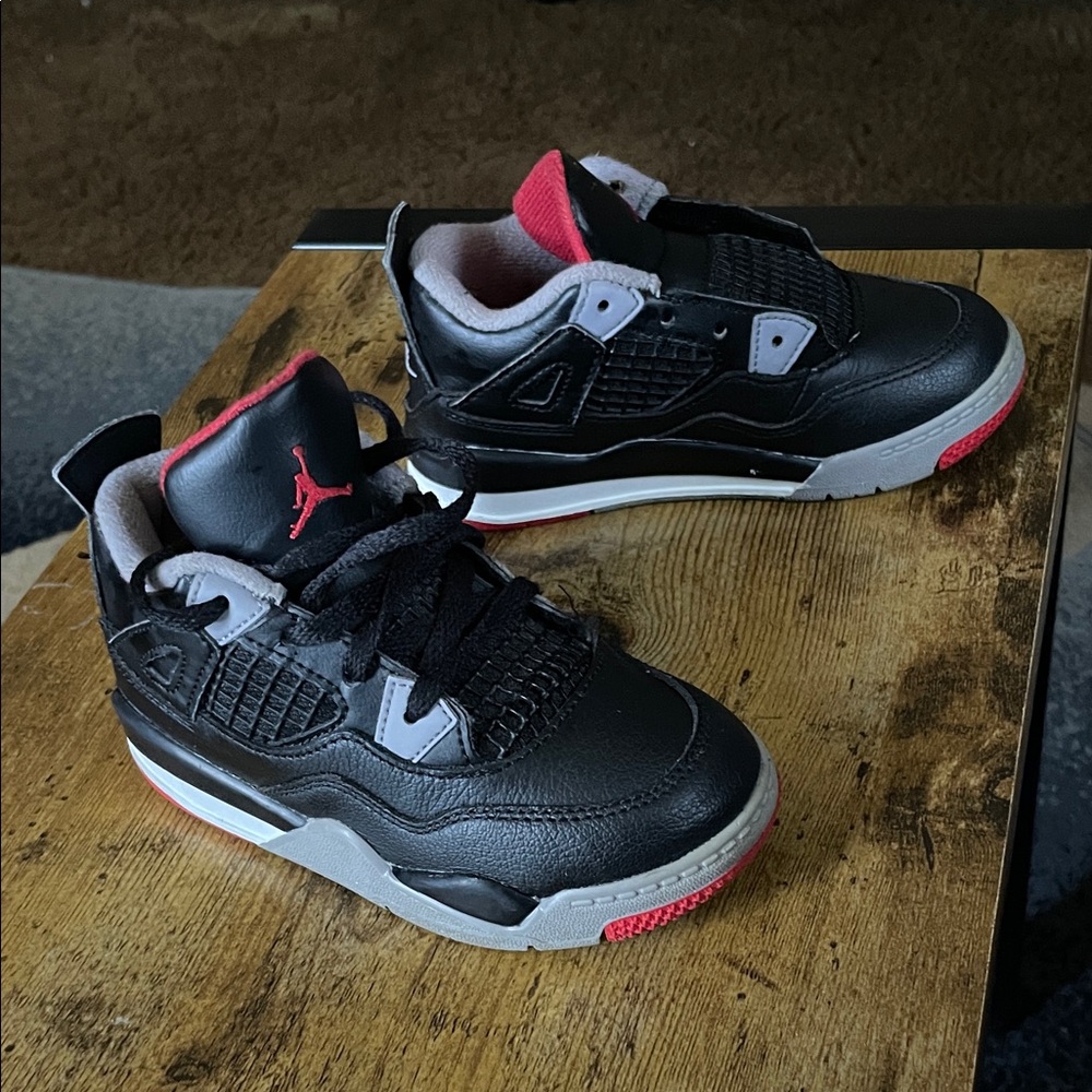 Jordan 4 Kids Black and Red . Good condition(one shoe is missing a shoe string)